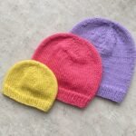 Three knitted beanies in yellow, pink and lilac in sizes from child to adult, from Craft Fix