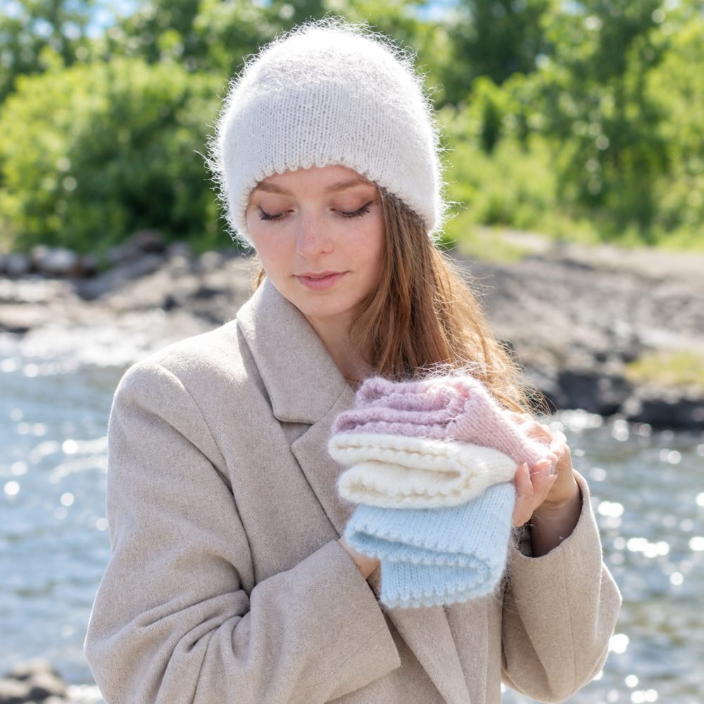 Soft white mohair-blend knitted hat worn with a winter coat, DROPS Frosted Rose Hat